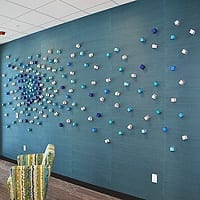 Cluster Scattered A and B | Blue Wall – left (Tonawanda, NY installation) | Dimensions: 12’ wide x 5’ high | Medium: acrylic paint on (qty 195) 2” wooden cubes | White Wall – right (Atlanta, Georgia Installation) | Dimensions: 20’ wide x 5’ high | Medium: acrylic paint on (qty 203) 2” wooden cubes